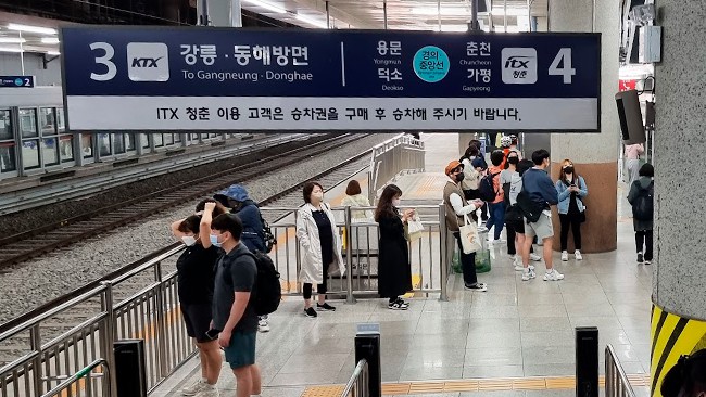 Station sign with English translation in South Korea